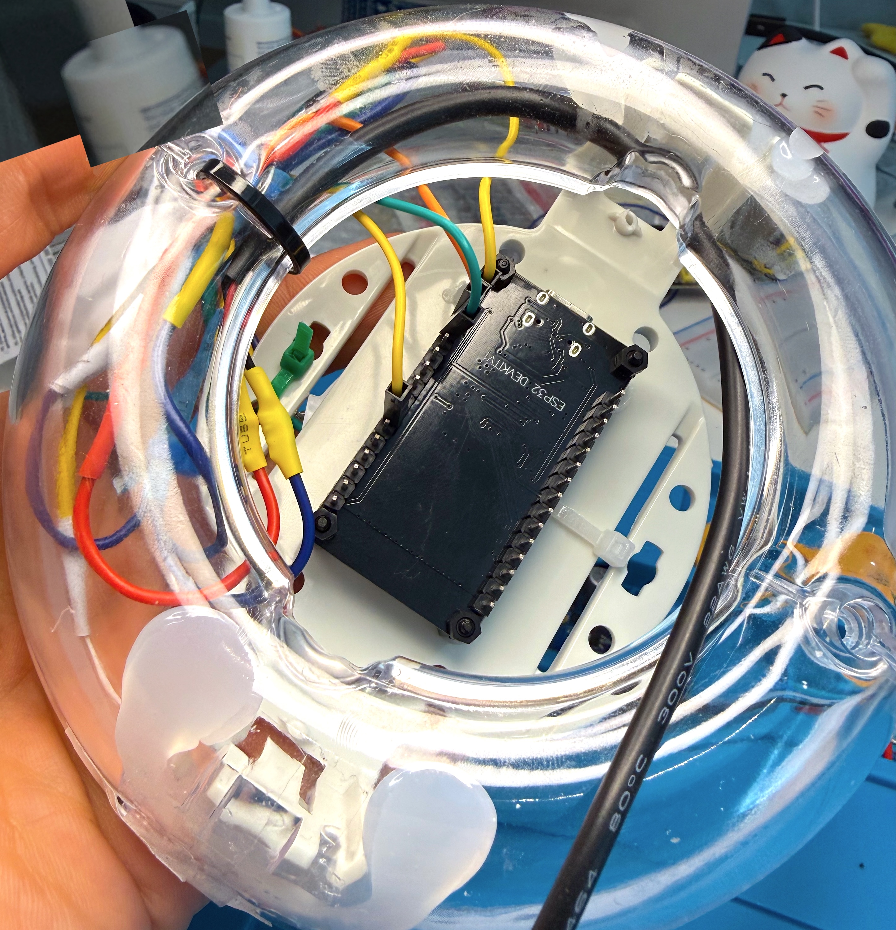 The ESP32 mounted under the base plate with the wiring routed and tied down inside the egg