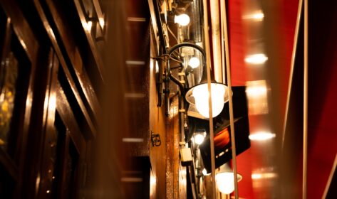 Bright lamps on a wall in a brown pub